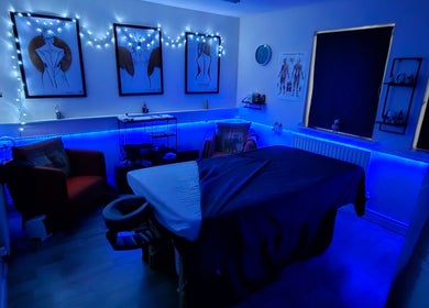 Relaxing massage room at Pure Turtle Wellbeing at The Pod, Burton Latimer, England, GB illuminated with calming blue lights.