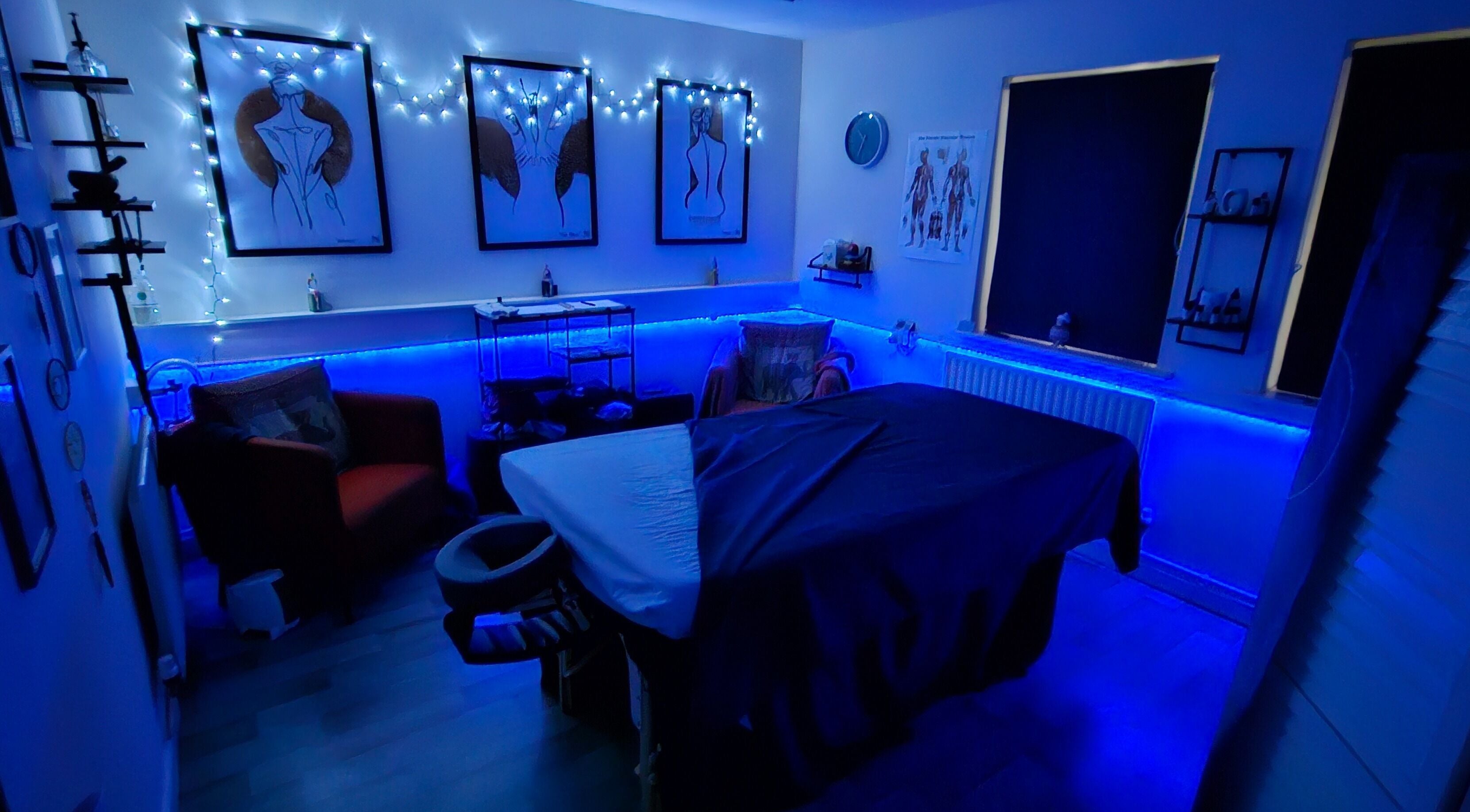 Relaxing massage room at Pure Turtle Wellbeing at The Pod, Burton Latimer, England, GB illuminated with calming blue lights.
