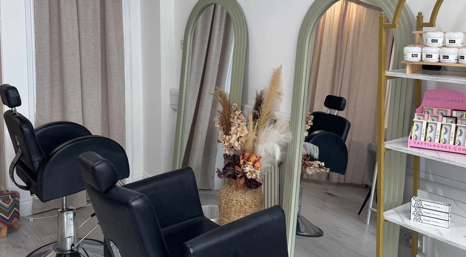 Stylish salon interior at Liv Beauty, Kilmallock, County Limerick, IE with elegant mirrors and floral decor.