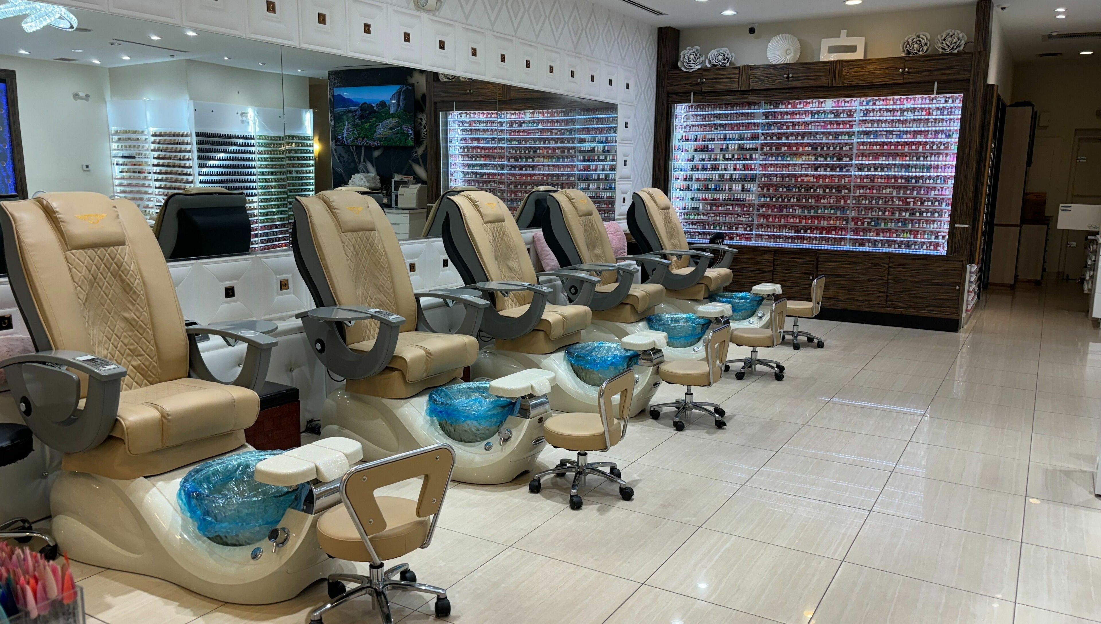 Elegant pedicure chairs at Elite Salon and Day Spa, Gilbert, Arizona, US, with a wide selection of nail polish.