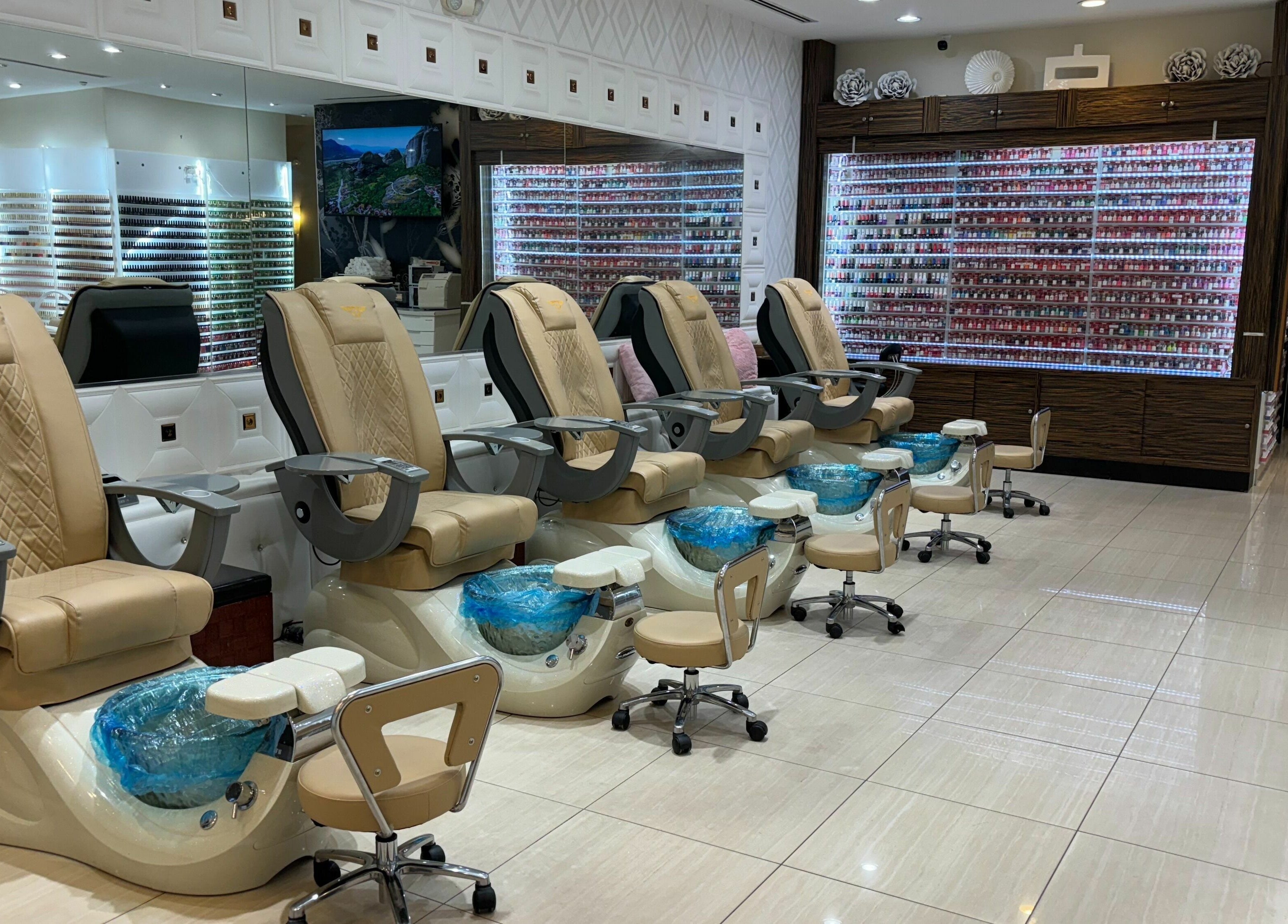Elegant pedicure chairs at Elite Salon and Day Spa, Gilbert, Arizona, US, with a wide selection of nail polish.