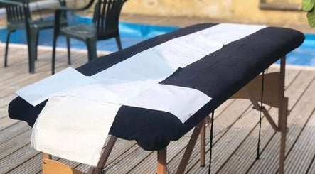 Outdoor massage table by the pool at Casa Prado Mobile, London, England, GB, offering serene wellness sessions.