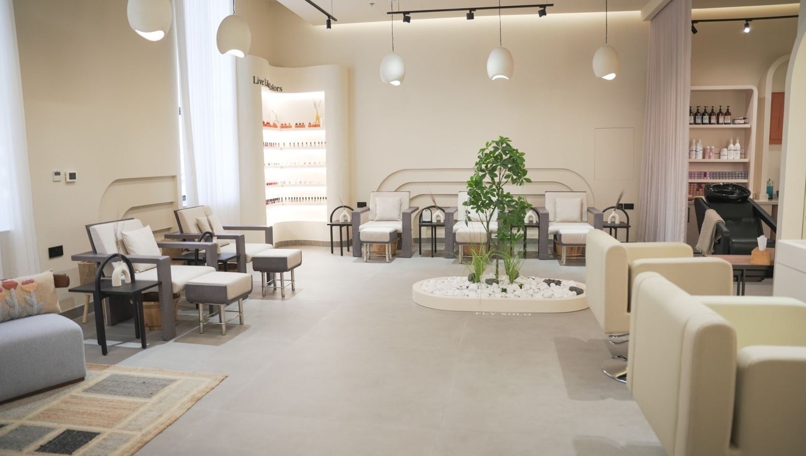 Sophisticated lounge interior at SOLO in Ajman, Ajman, AE with modern chairs and lush greenery.