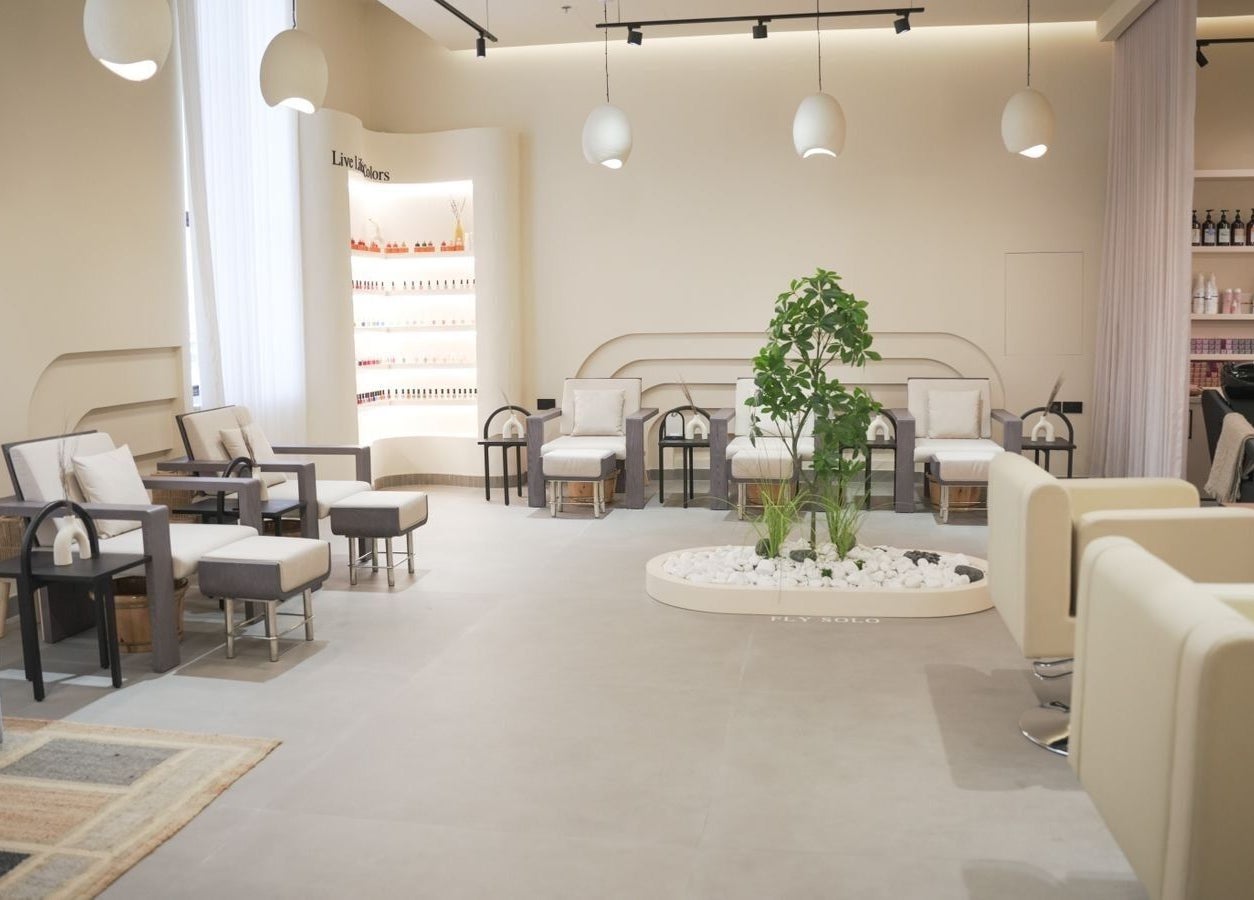 Sophisticated lounge interior at SOLO in Ajman, Ajman, AE with modern chairs and lush greenery.