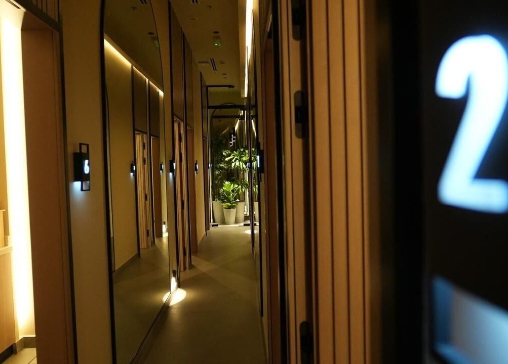 Warmly lit hallway at SOLO in Ajman, Ajman, AE, featuring elegant decor and ambient lighting.