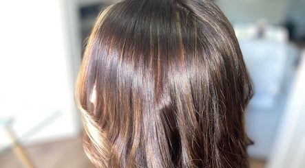 Shiny brunette hair styled in waves at Hair by Adele, Winsford, England, GB.