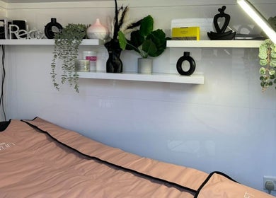 Relaxing treatment room at LaBella Body Sculpting, Runcorn, England, GB, featuring a cozy bed and chic decor.