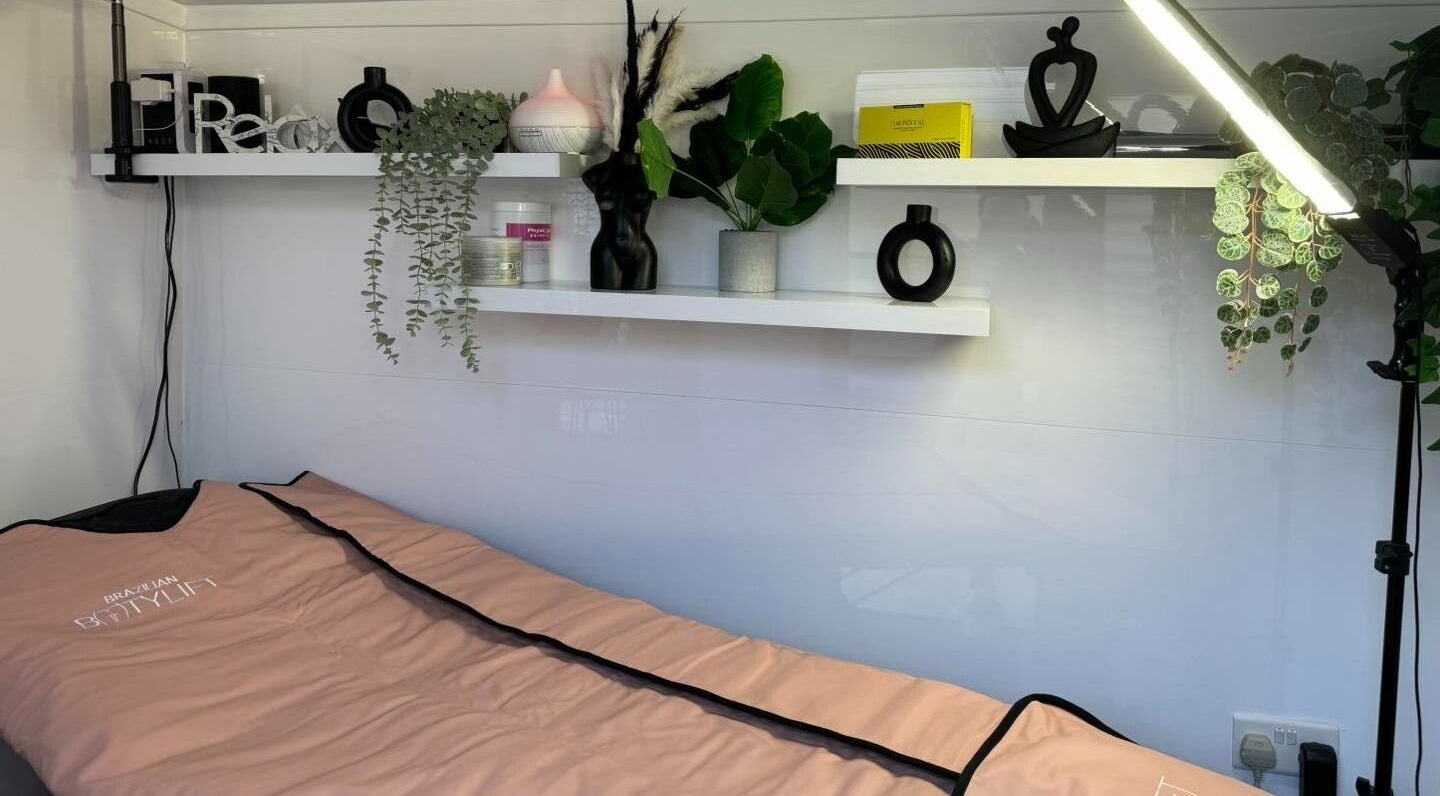 Relaxing treatment room at LaBella Body Sculpting, Runcorn, England, GB, featuring a cozy bed and chic decor.