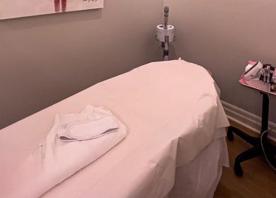 Relaxing treatment room at Royal Eden Spa, Toronto, Ontario, CA, featuring a cozy massage bed and soft lighting.