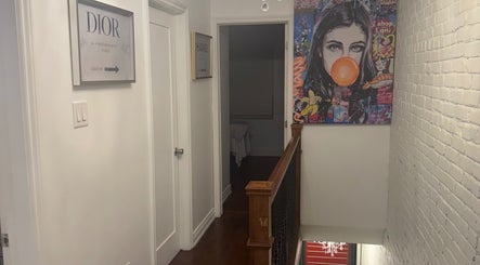 Art-filled hallway at Royal Eden Spa, Toronto, Ontario, CA, featuring vibrant decor and artwork.