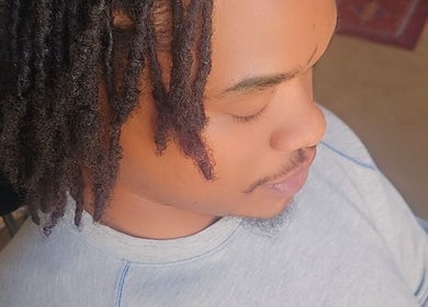 Person with styled hair relaxing at Nurishin Knotts, Charlotte, North Carolina, US.