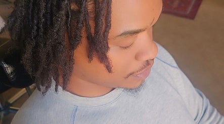 Person with styled hair relaxing at Nurishin Knotts, Charlotte, North Carolina, US.