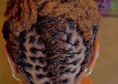 Braided hairstyle at Nurishin Knotts in Charlotte, North Carolina, US, showcasing detailed hair artistry.