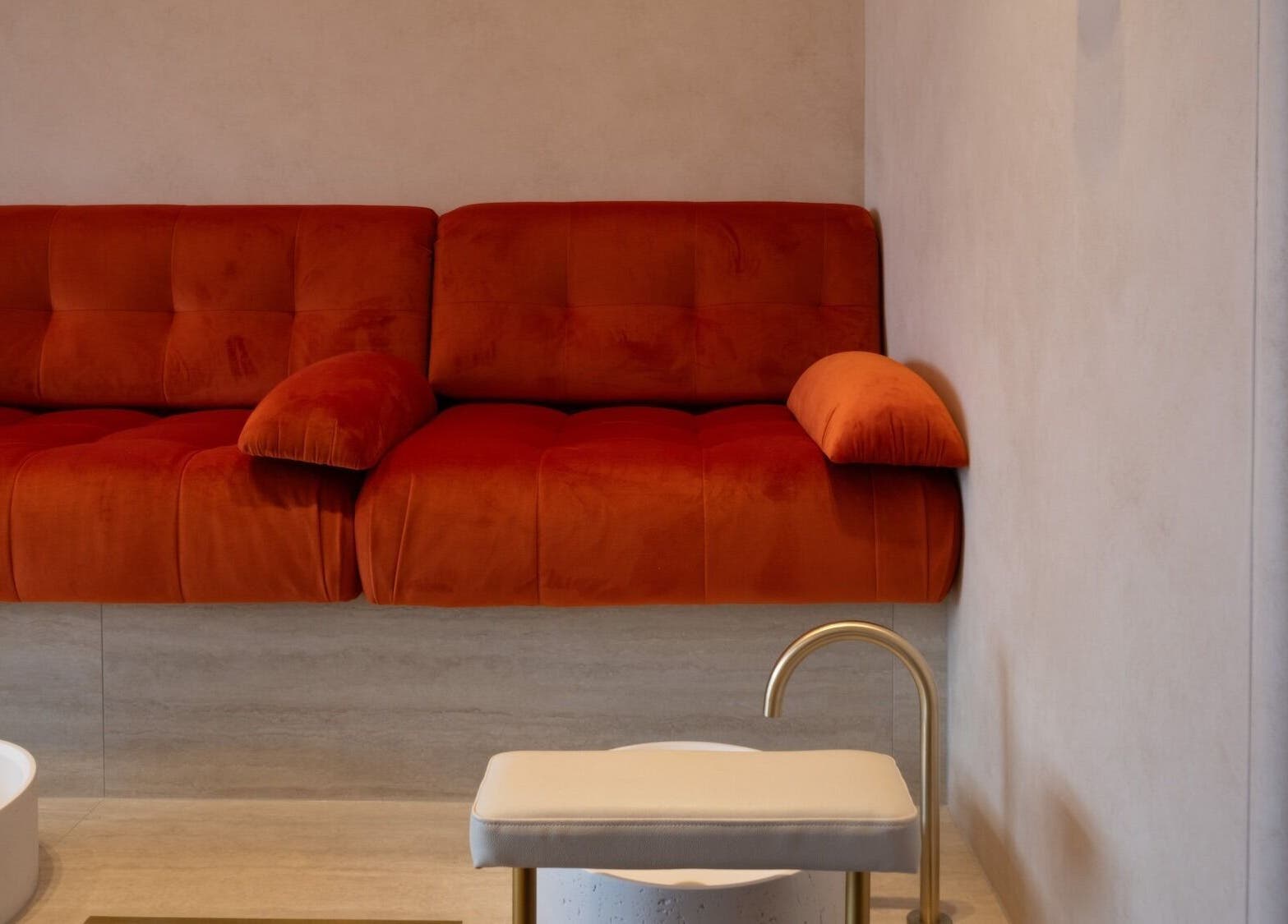 Inviting red sofa at 1999 House of Nails - Ferrymead, Christchurch, Canterbury, NZ. Perfect for relaxation.
