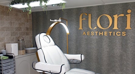 Luxurious treatment room at Flori Aesthetics, Whittlesey, England, GB, featuring a plush white chair and modern decor.
