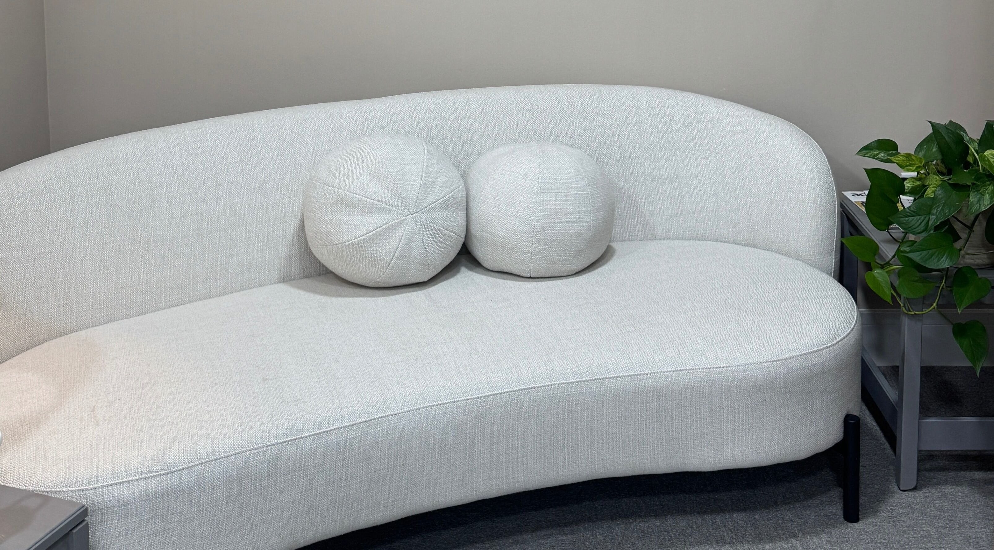 Modern white sofa with cushions at Flori Aesthetics, Stamford, England, GB, enhancing relaxation.