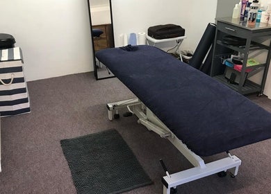 Therapy room at Farnborough Sports Massage in Farnborough, England, GB with massage table and soothing decor.