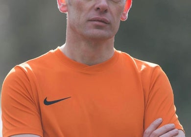 Professional sports massage therapist at Farnborough Sports Massage, Farnborough, England, GB in an orange shirt.