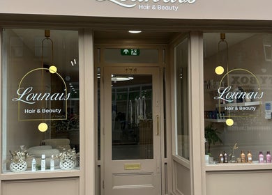 Front of Lounais - Formerly Guys and Dolls in Burton Upon Trent, England, GB showcasing elegant signage.
