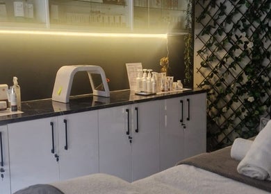 Relaxing treatment area at Wink Beauty Salon & Spa, Sandton, Gauteng, ZA, featuring plush towels and products.