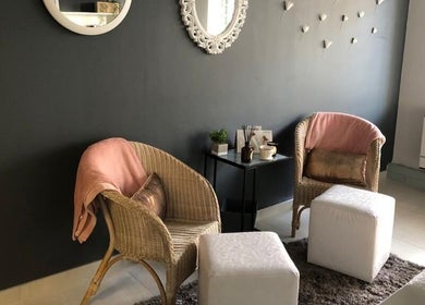 Cozy relaxation area at Wink Beauty Salon & Spa, Sandton, Gauteng, ZA, featuring wicker chairs and soft decor.