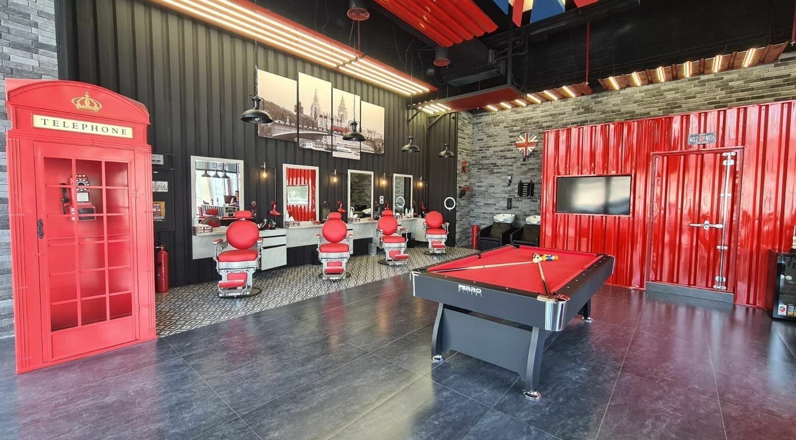 Chic interior of London Base Barbershop - Business Bay, Dubai, AE featuring red accents and modern design.