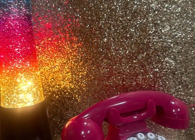 Retro pink phone and colorful lamp at Emi Nail Art, Gibraltar, GI, enhancing the venue's vibrant ambiance.