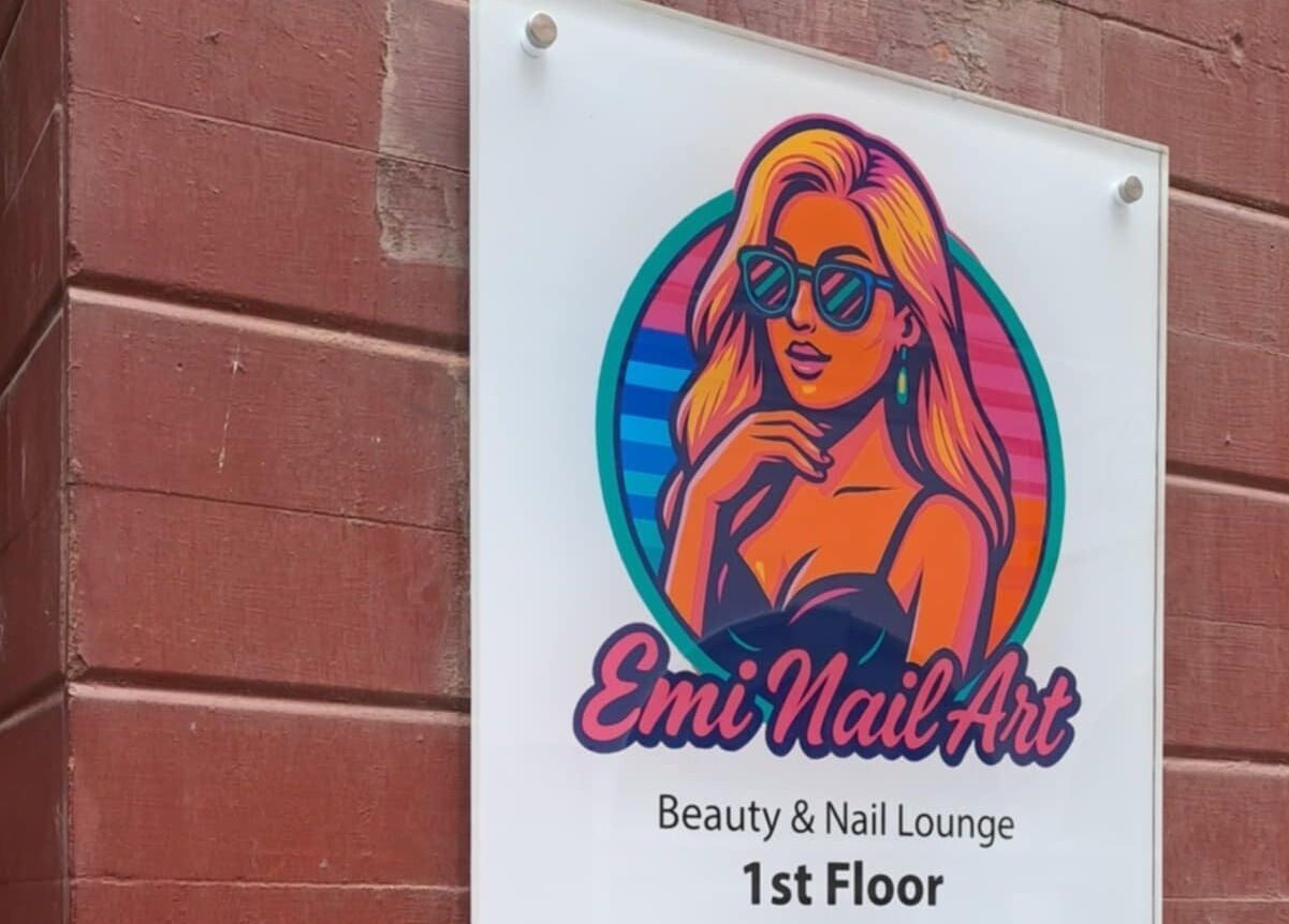 Emi Nail Art signage on a brick wall at 1st Floor, Gibraltar, GI.