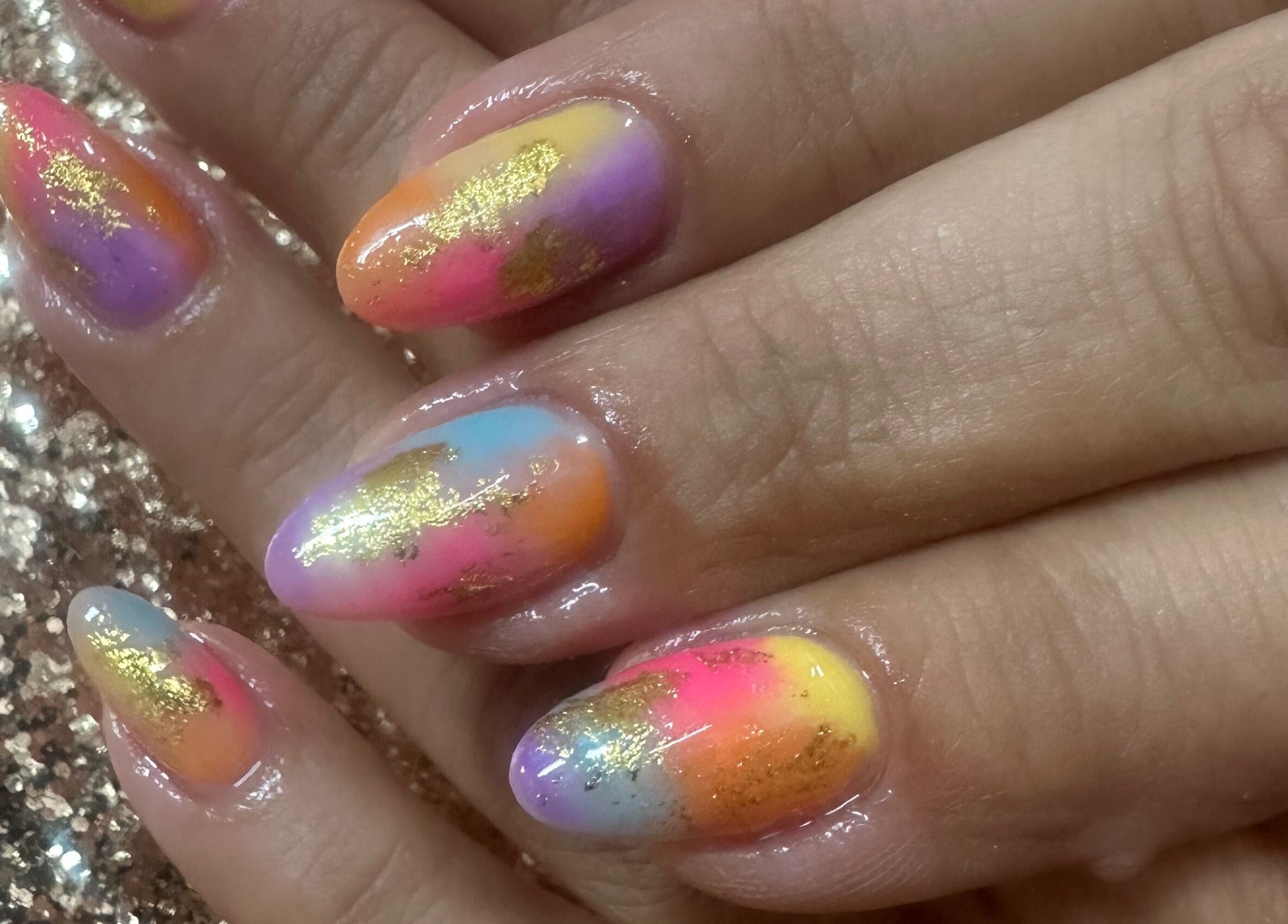 Colorful nail art with gold accents at Emi Nail Art, Gibraltar, GI.