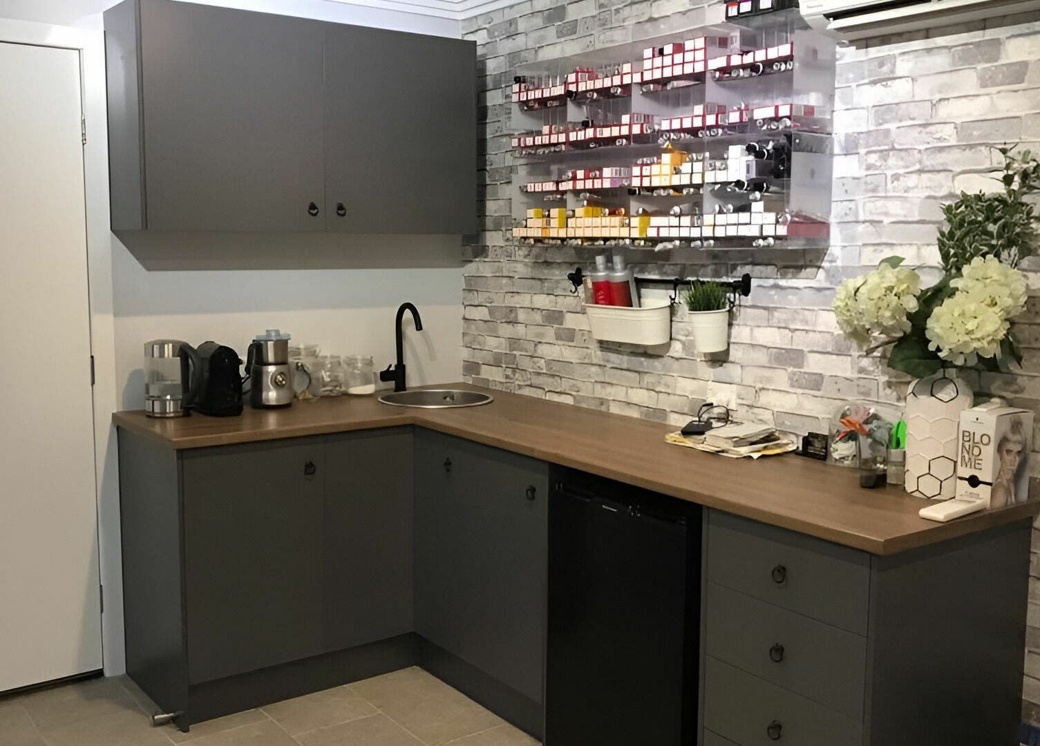 Modern salon interior at Rachael's House of Colour, Stapylton, QLD, AU featuring sleek cabinetry and hair products.