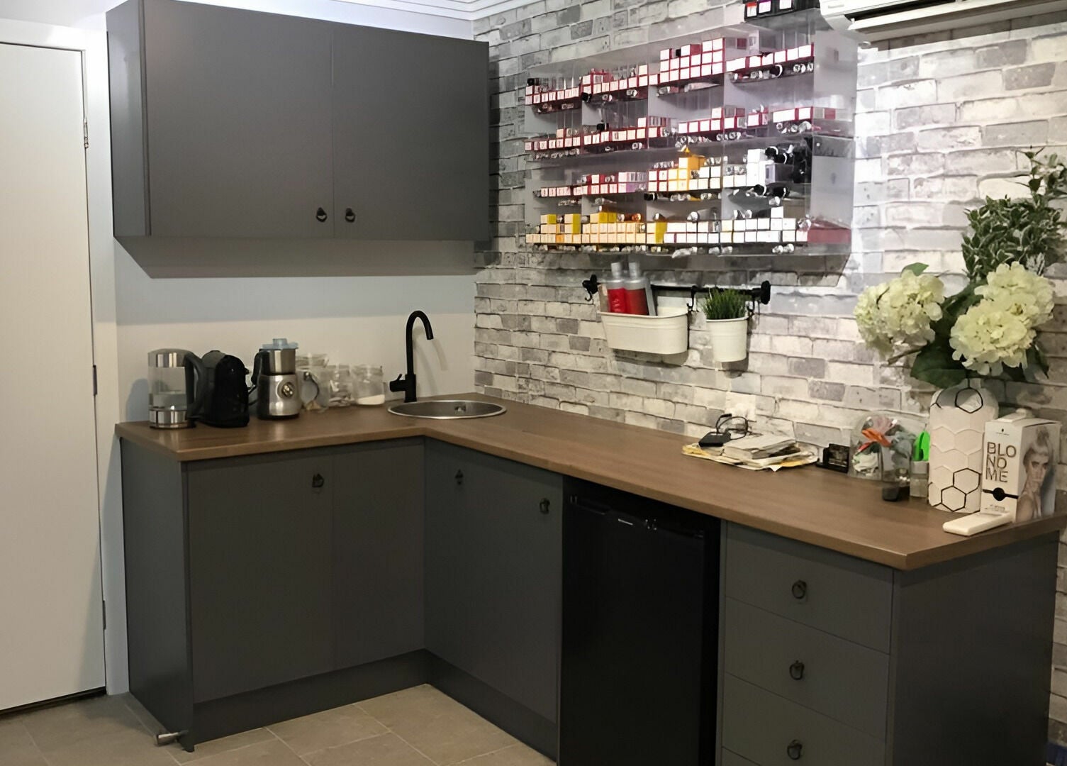 Modern salon interior at Rachael's House of Colour, Stapylton, QLD, AU featuring sleek cabinetry and hair products.