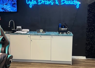 Interior of Lyla Brows & Beauty, Deerfield Beach, Florida, US, featuring a stylish chair and neon sign.