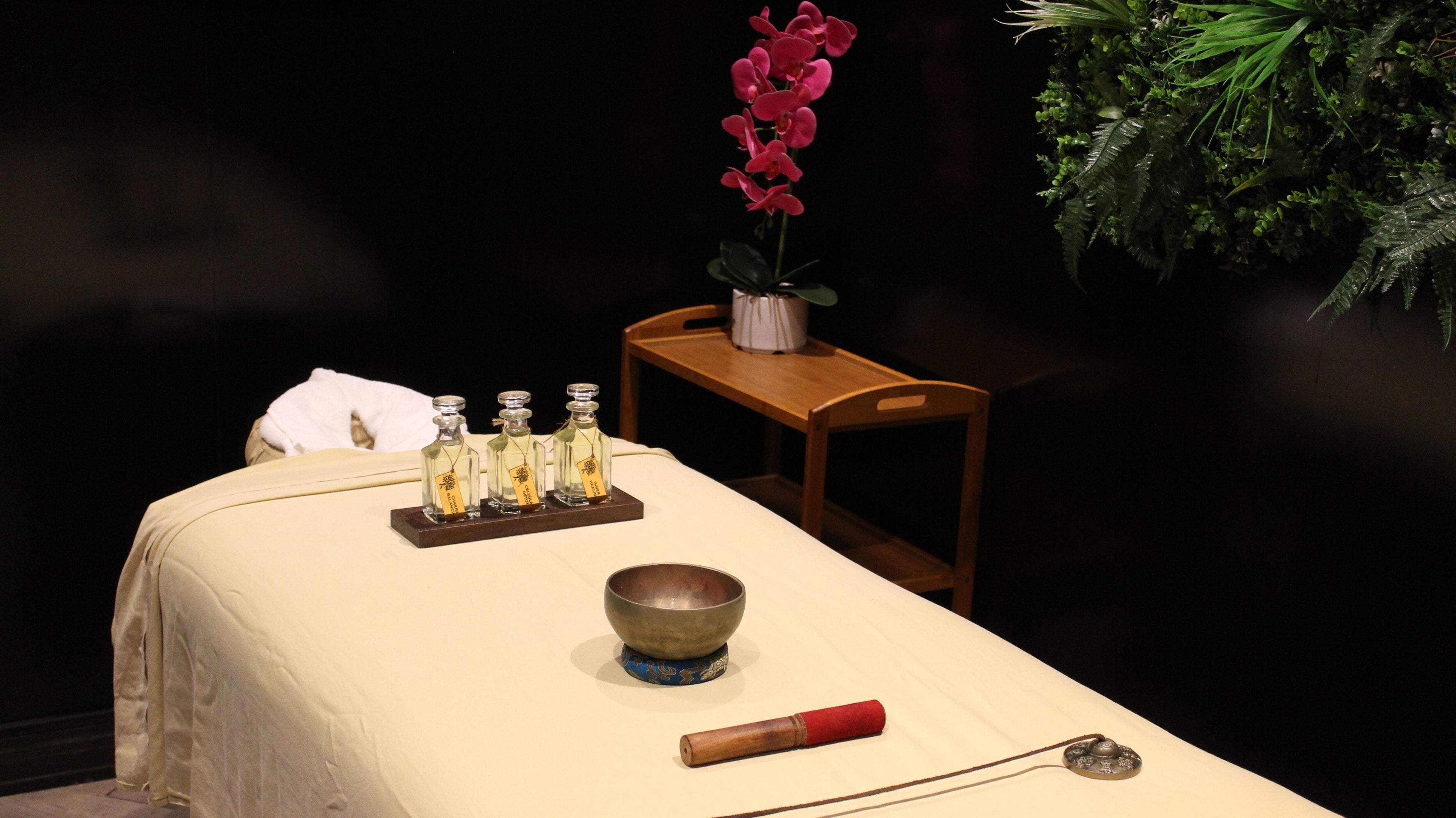 Relaxing massage setup at Rayya Wellness | The First Collection Marina, Dubai, AE featuring oils and a Tibetan bowl.