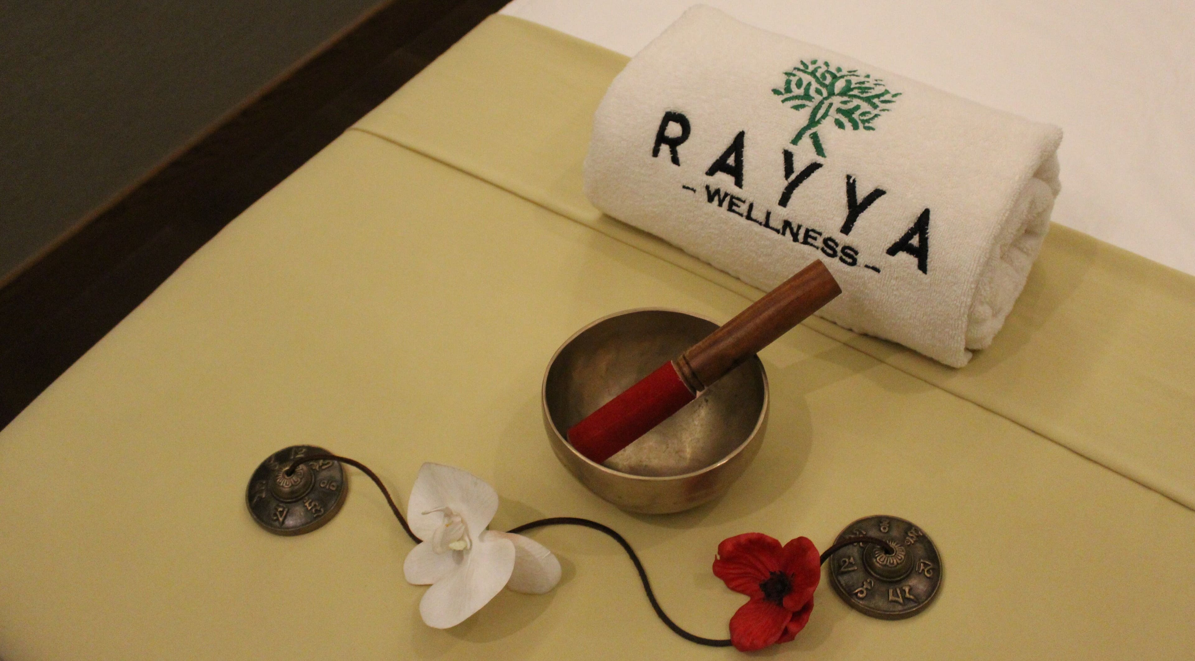 Tranquil setup at Rayya Wellness, the First Collection | Business Bay, Dubai, Dubai, AE with towel, bowl, and flowers.