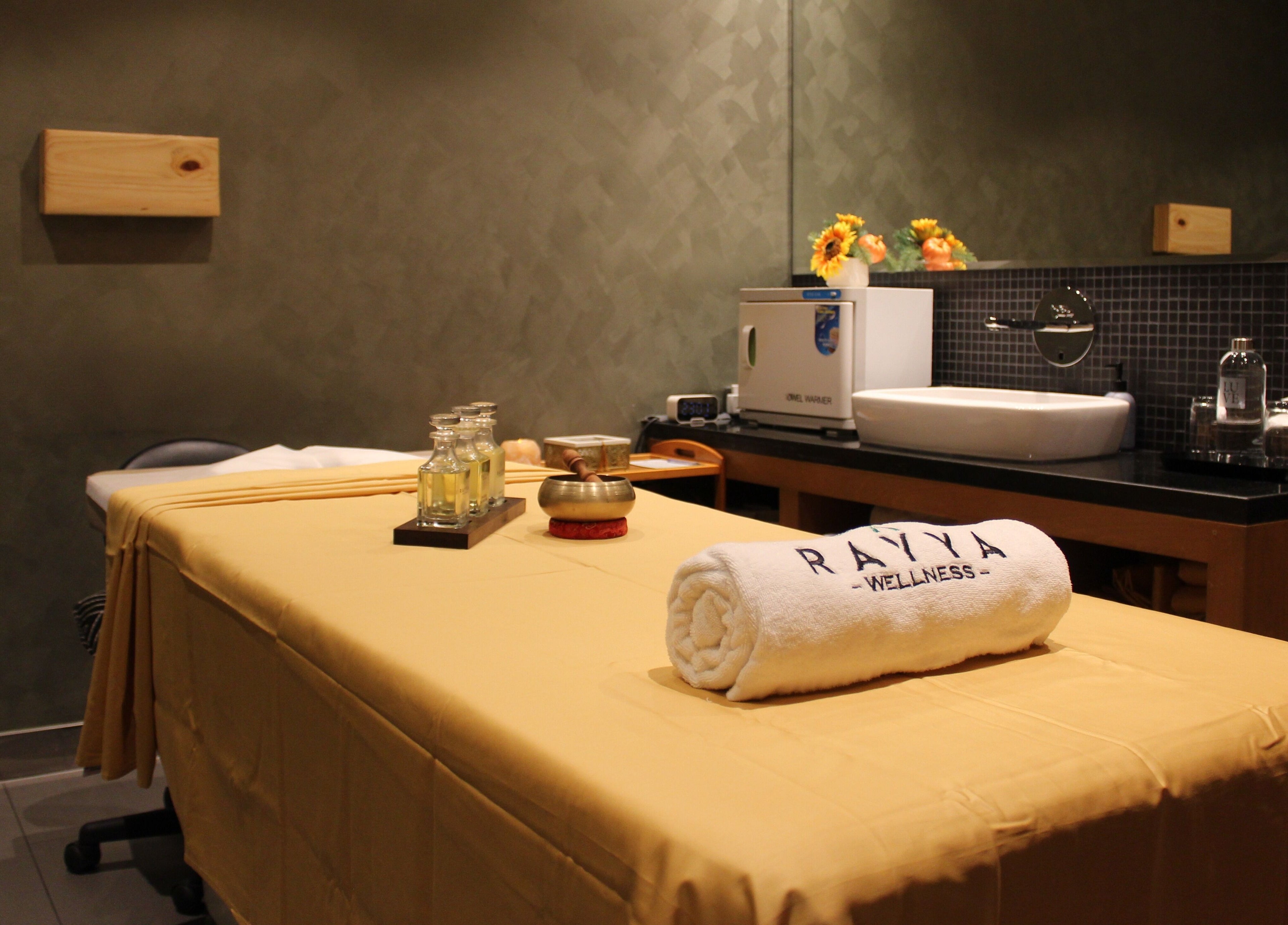 Calm spa room at Rayya Wellness | TRYP, Al Saef, Dubai, AE with massage table and soothing decor.