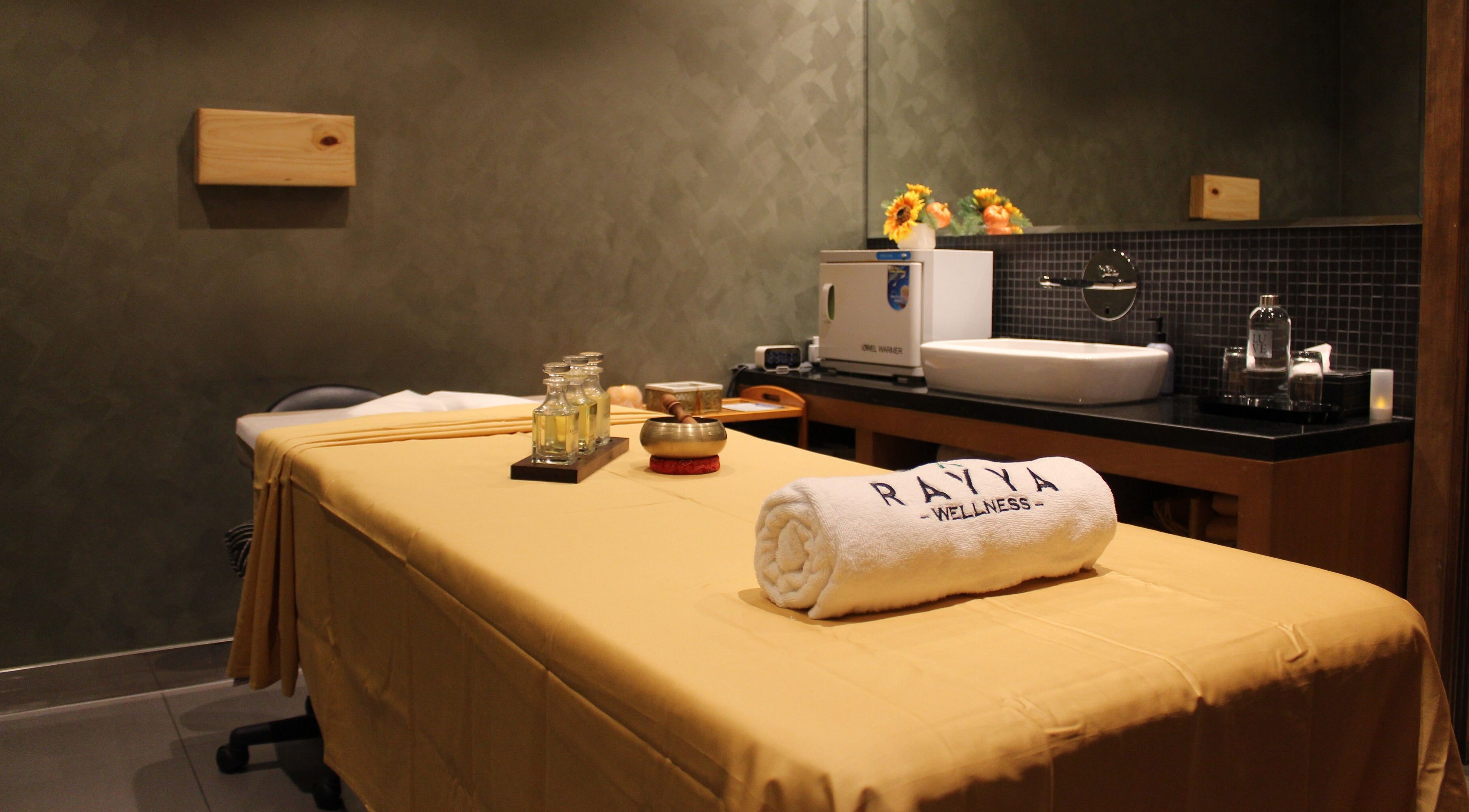 Calm spa room at Rayya Wellness | TRYP, Al Saef, Dubai, AE with massage table and soothing decor.