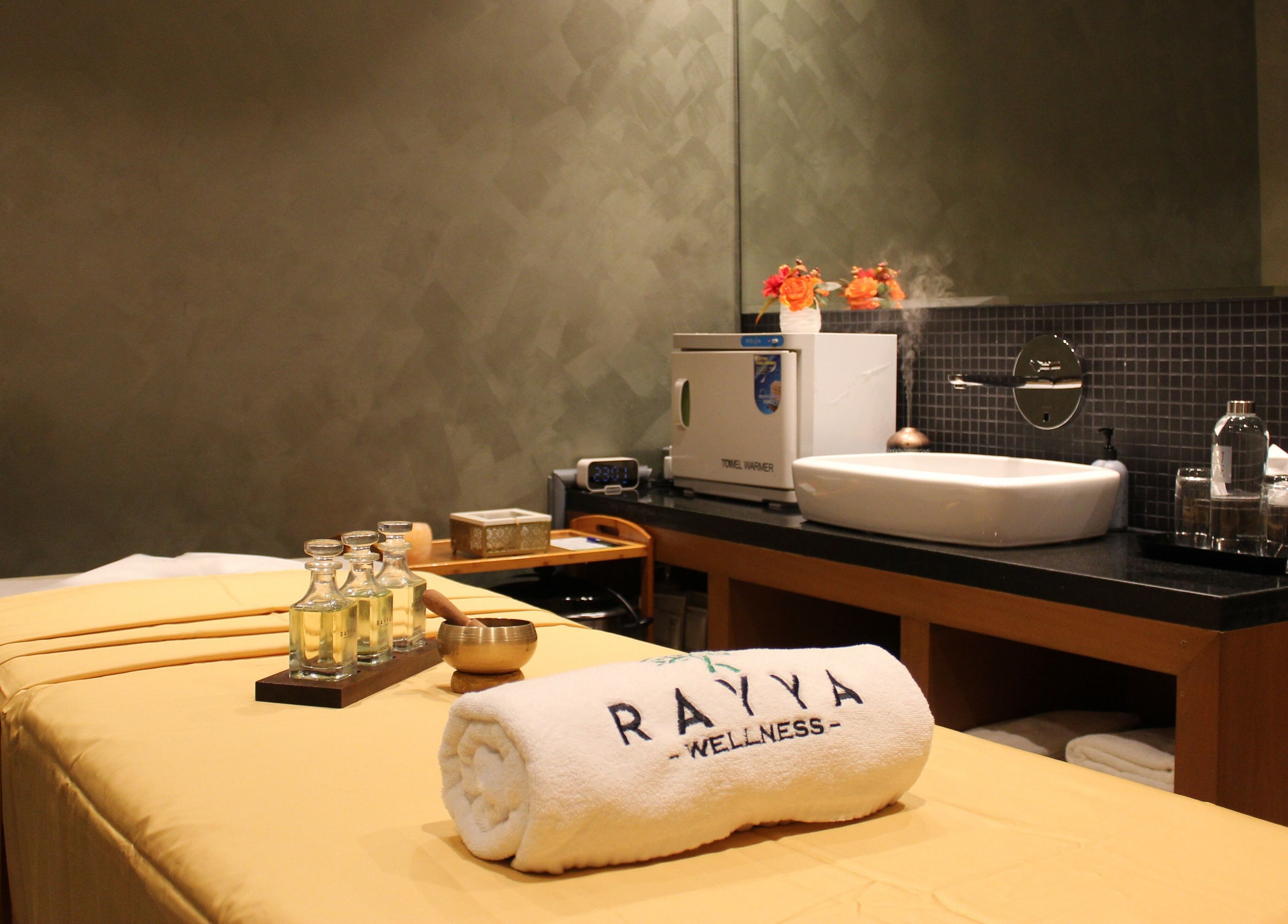 Relaxing spa room at Rayya Wellness | TRYP, Al Saef, Dubai, AE featuring massage table and oils.