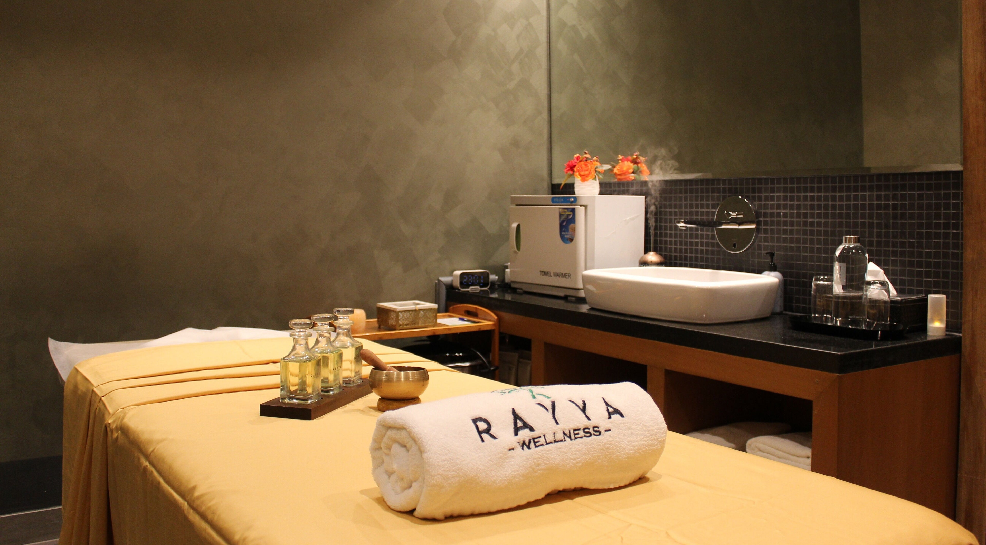 Relaxing spa room at Rayya Wellness | TRYP, Al Saef, Dubai, AE featuring massage table and oils.