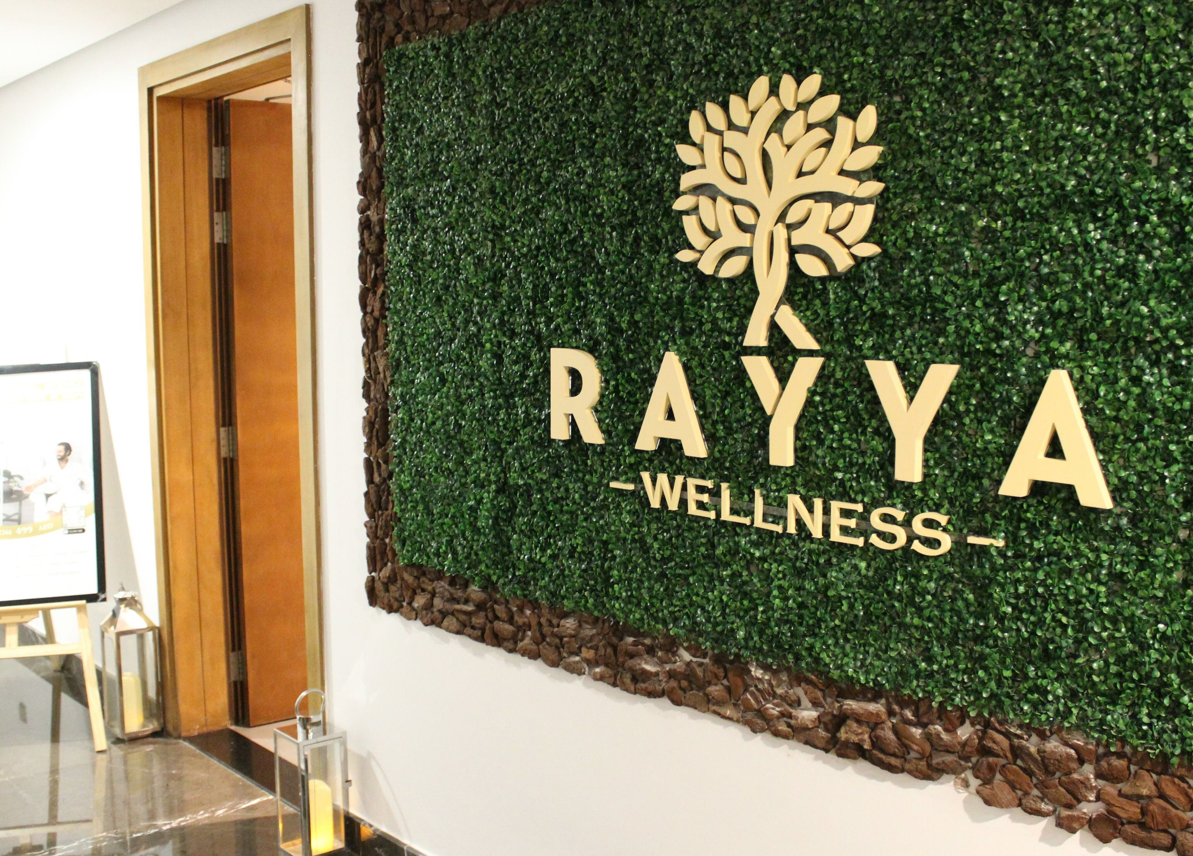 Rayya Wellness entrance with lush green decor at TRYP, Al Saef, Dubai, AE.
