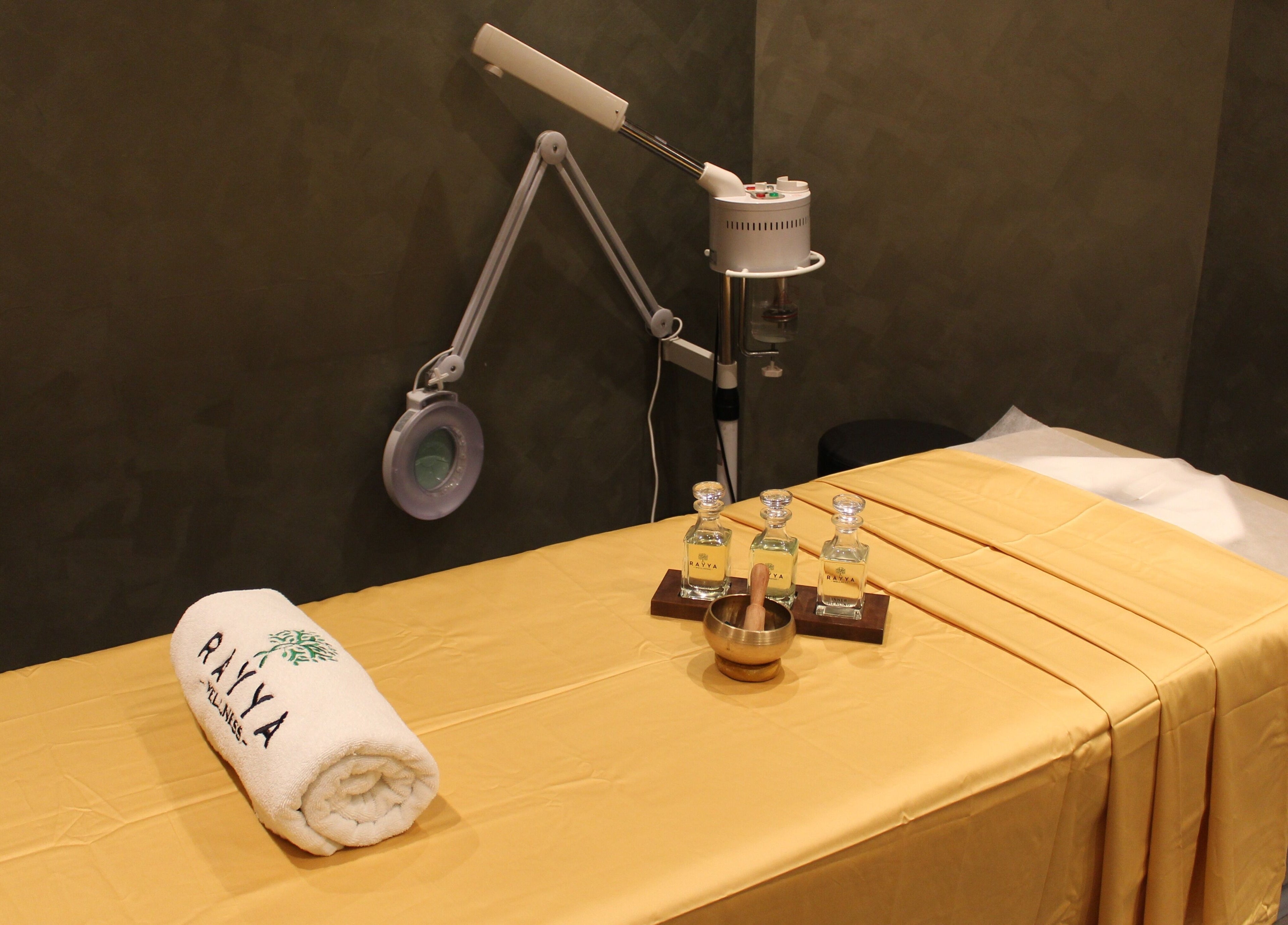 Massage room at Rayya Wellness | TRYP, Al Saef, Dubai, AE featuring a prepared bed and spa essentials.