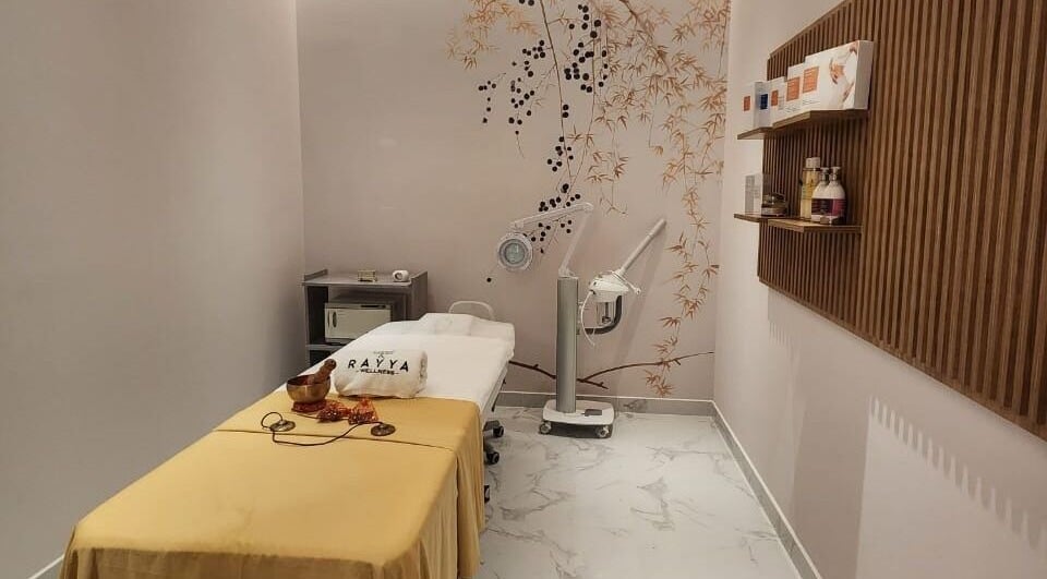 Tranquil treatment room at Rayya Wellness, Hotel Local, Dubai, AE, featuring massage bed and calming decor.