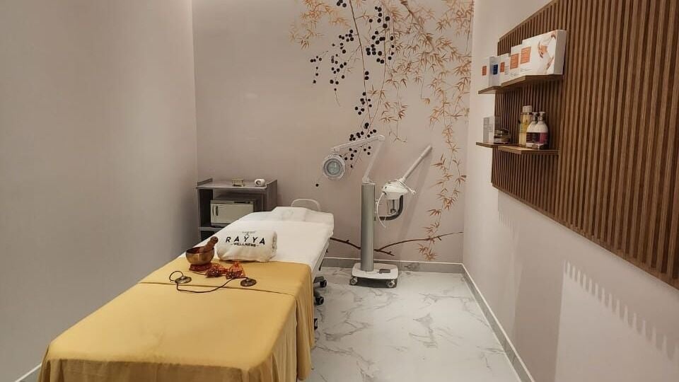 Tranquil treatment room at Rayya Wellness, Hotel Local, Dubai, AE, featuring massage bed and calming decor.