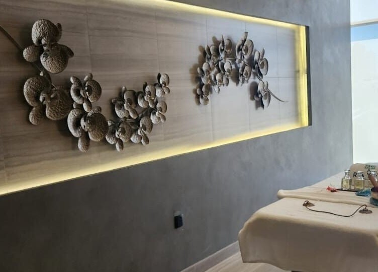 Relaxing massage room at Rayya Wellness, Hotel Local, Dubai, AE with elegant wall decor and treatment bed.