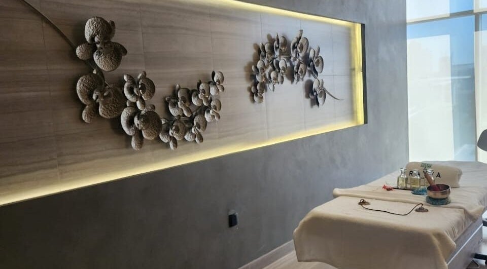 Relaxing massage room at Rayya Wellness, Hotel Local, Dubai, AE with elegant wall decor and treatment bed.
