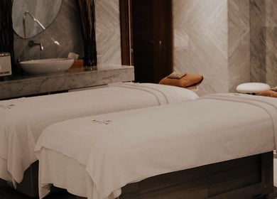 Luxurious spa treatment room at Rayya Wellness, Sky Bay Hotel, Dubai, AE, featuring plush massage beds.
