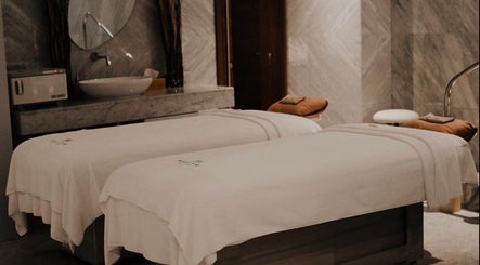 Luxurious spa treatment room at Rayya Wellness, Sky Bay Hotel, Dubai, AE, featuring plush massage beds.