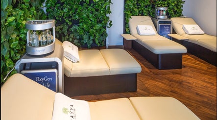 Luxurious lounge at Rayya Wellness, Sky Bay Hotel, Dubai, AE with serene green walls and beige recliners.