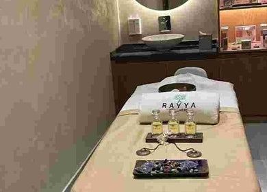 Serene spa room at Rayya Wellness, Sky Bay Hotel, Dubai, AE with massage oils and elegant decor.