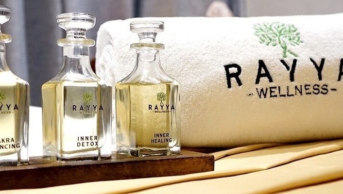 Elegant oils and towel at Rayya Wellness, The First Collection, JVC in Dubai, AE, symbolize luxury and relaxation.