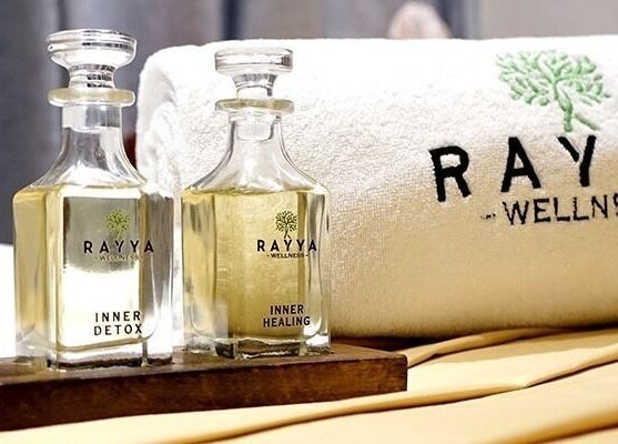 Elegant oils and towel at Rayya Wellness, The First Collection, JVC in Dubai, AE, symbolize luxury and relaxation.